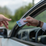 Crime: Policeman gives driver a traffic ticket.